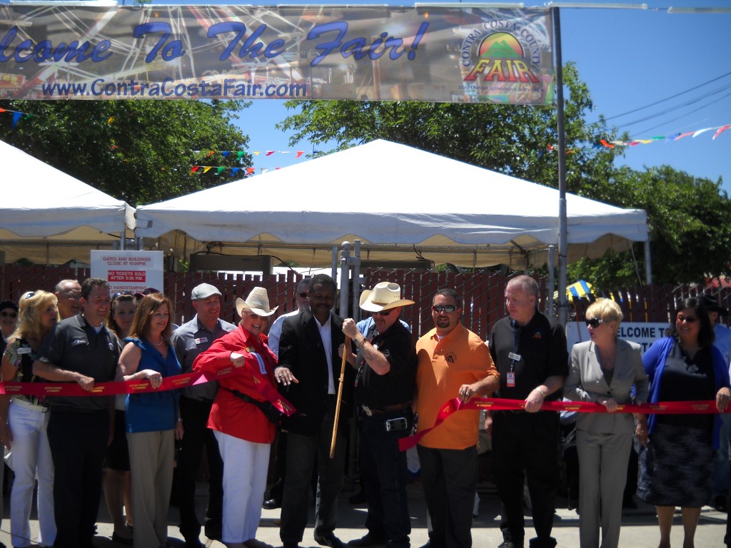 Steve Limrite, President of the Contra Costa Fair Board, along with Antioch Mayor Wade Harper, other Board members and Antioch Chamber of Commerce representatives cut the ribbon marking the official opening of the 2013 Contra Costa County Fair.
