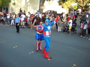 Cynthia & Walter Ruehlig aka Wonder Woman & Captain America participate in the July 4th parade.