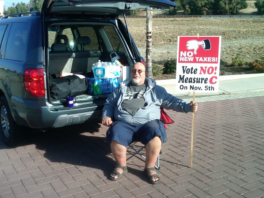 Antioch resident Karl Dietzel holds a No on Measure C campaign sign at the entrance of In-Shape on Lone Tree Way, on Friday morning, October 11.