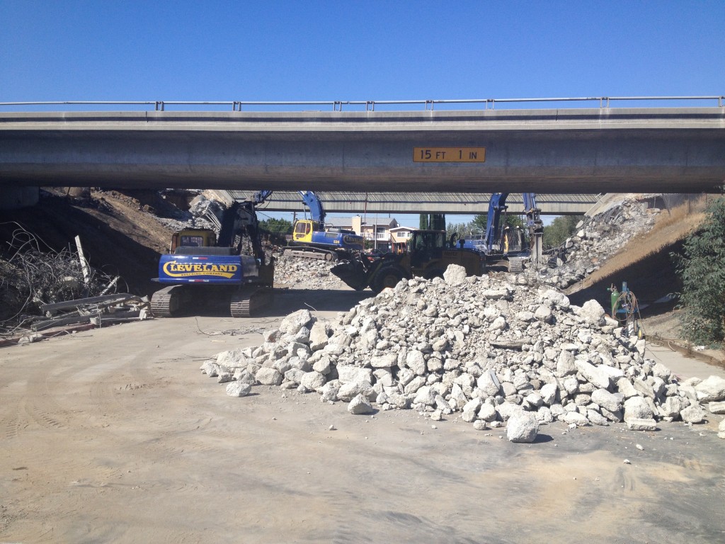 Demolition crews tear down the old Highway 4 overpass above Cavallo Road, and clean up the debris on Saturday, September 27, 2014.