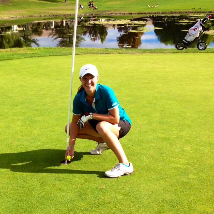Danielle French reaches for her hole-in-one ball. Photo by golf coach Brian Kofford