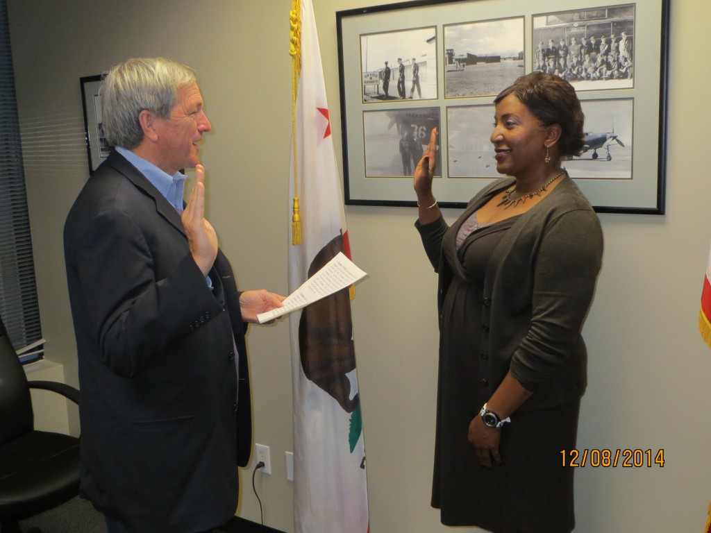 State Senator Mark DeSaulnier gives the oath of office to new Antioch School Board Trustee Debra Vinson, at his office, on Monday, December 8, 2014.