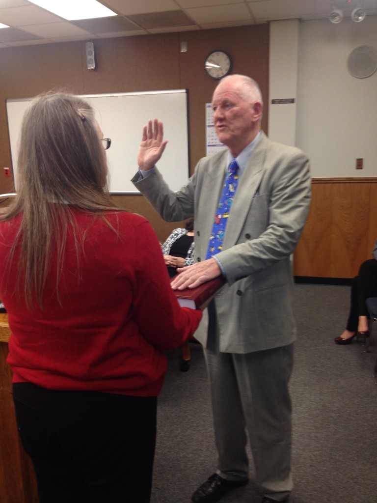 Walter Ruehlig takes his oath of office for the Antioch School Board, administered by Acting Board President Claire Smith on Wednesday afternoon, December 10, 2014.