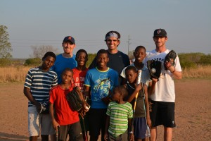 Part of the Baseball Miracles team with happy new baseball players in South Africa.