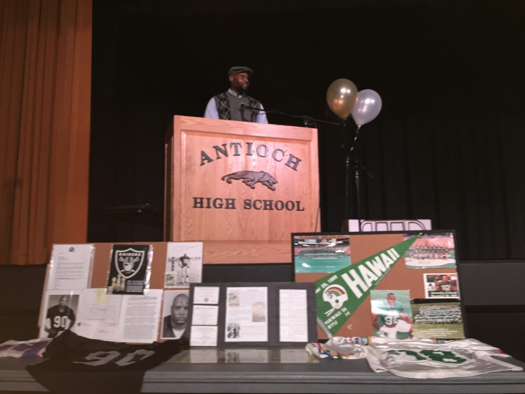 Akili Calhoun speaks at Antioch's annual Martin Luther King Day event on Monday. Highlights of his college and NFL career were on display.