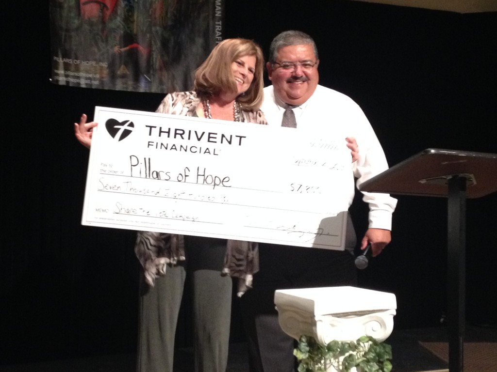 Debra Brown displays the check presented to her by Manny Soliz, Jr. at a fundraiser last fall.