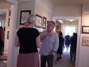 Local art lover, Tom Lamothe, discusses artworks with Antioch High School Teacher art teach Dalu Lingemann at the 2014 reception.