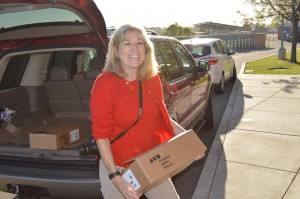 Club member and Antioch School Board Trustee Barbara Cowan delivers one of the last boxes of dictionaries to an Antioch elementary school.
