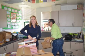 Dr. Stacey Duckett and Club President Bernie Szalaj prepare the dictionaries for distribution.