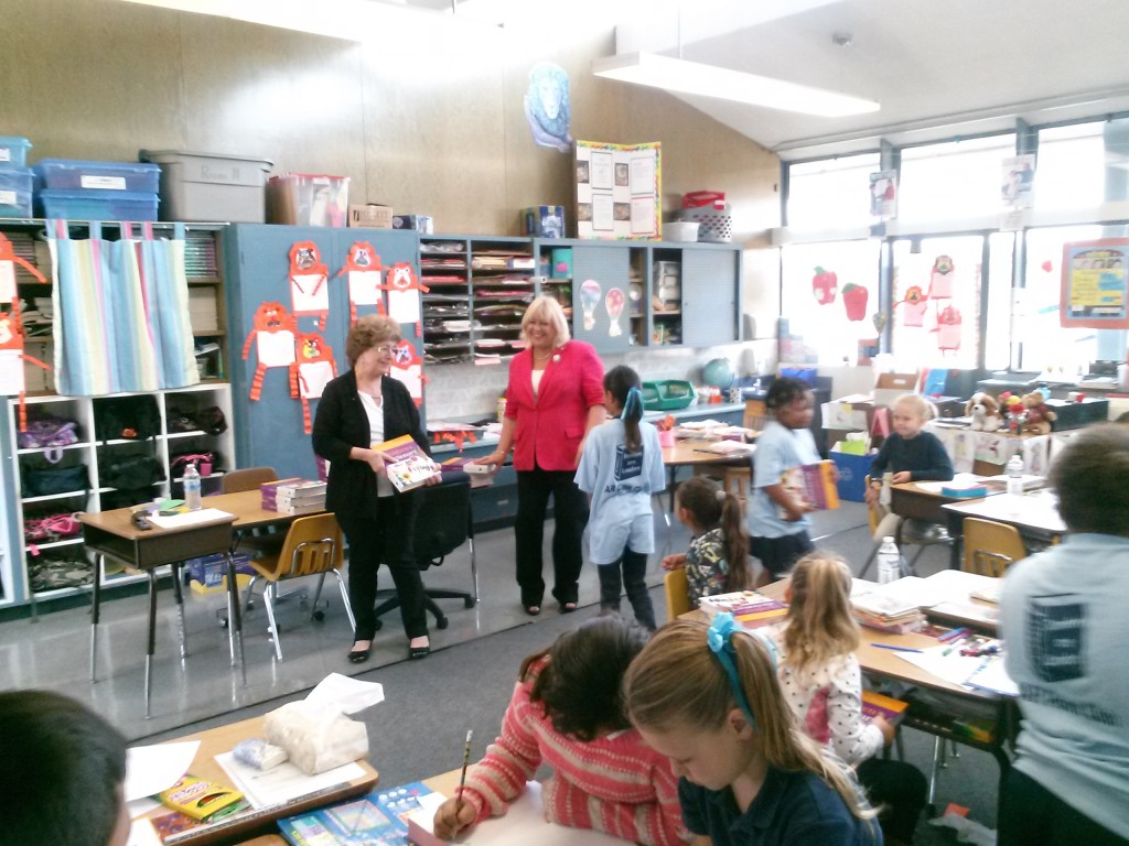 Gloria Martin and Christine O'Brien present dictionaries to third graders at Kimball Elementary, last October. Photo by Minh Nguyen
