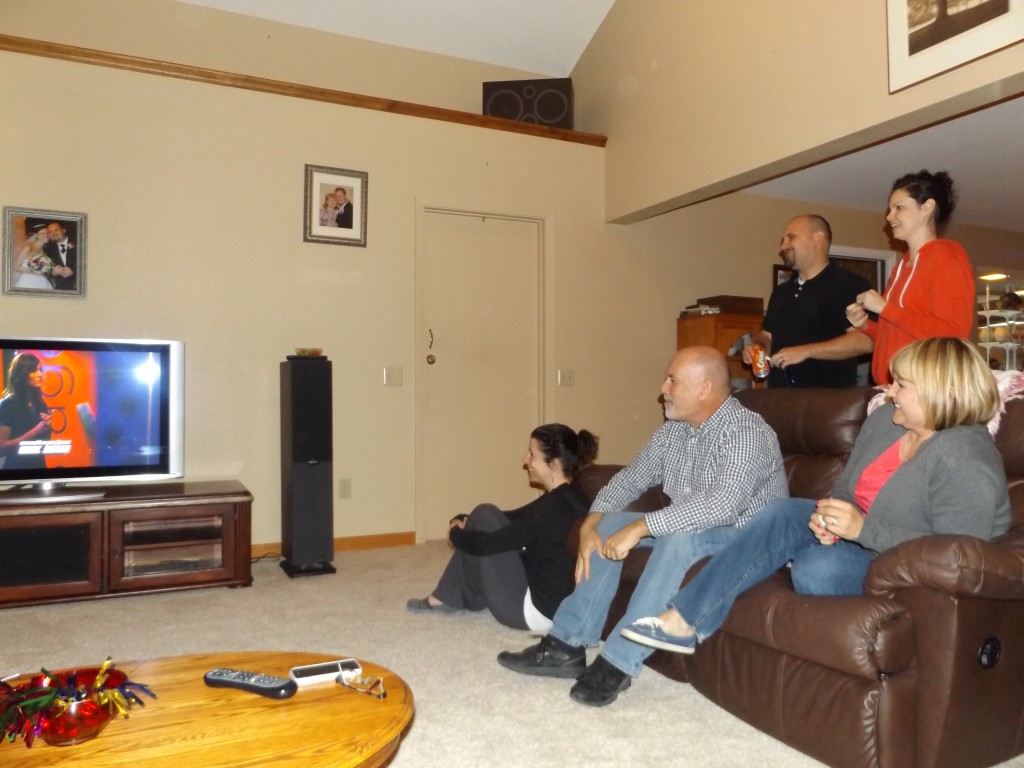 The Morgan family and friends watch Ashley perform at her parents' home, Tuesday night.