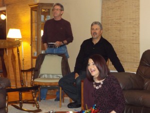 Ashley's voice teacher, Nuhad Levasseur, right, her husband Michael, to her left, and Walt, a Morgan family friend, watch Ashley's performance at her parents' home, Tuesday night.