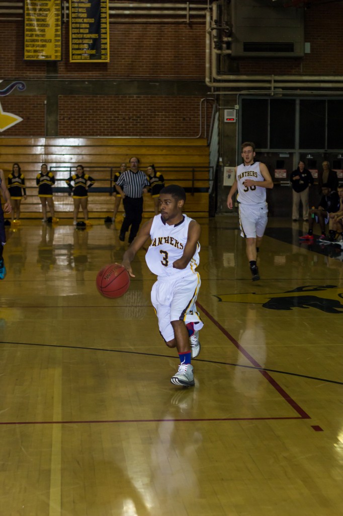 Damani Jackson-Wright drives down the court. By Michael Pohl.