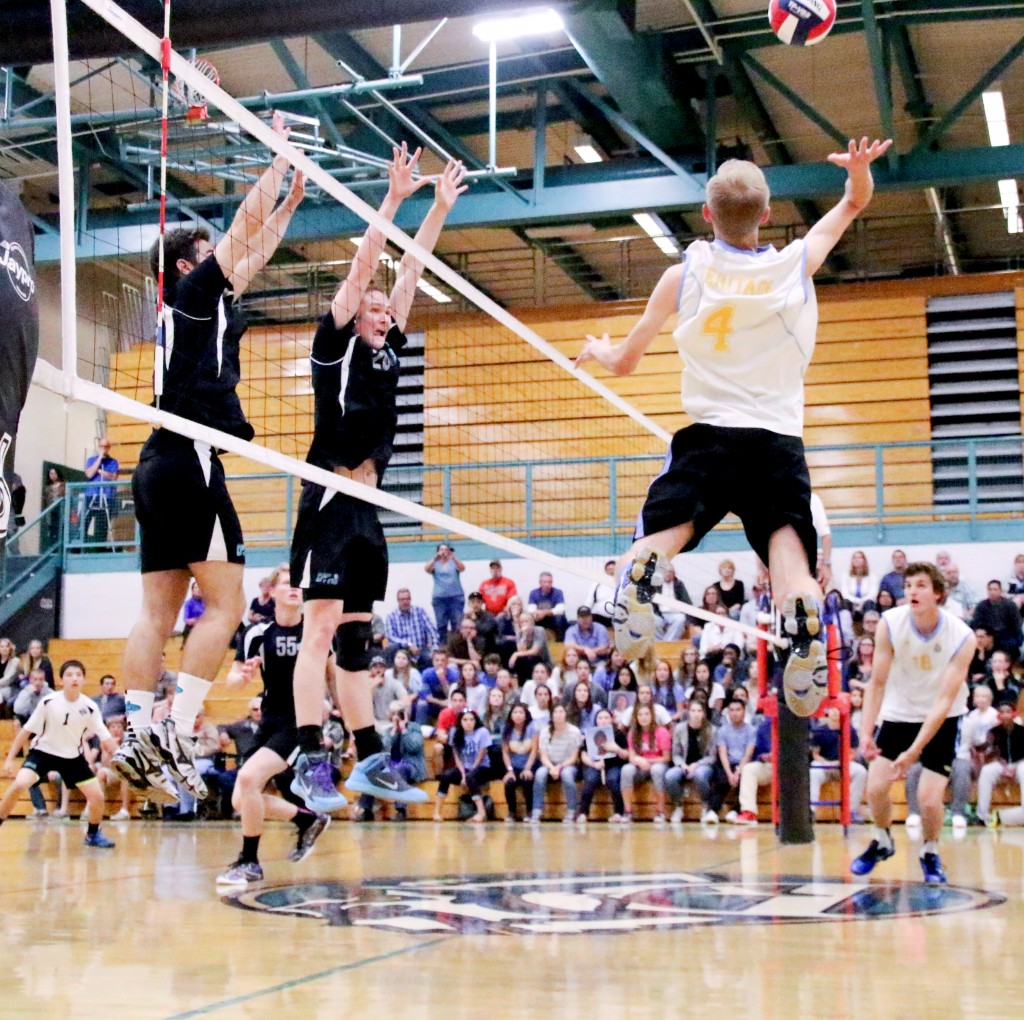 Deer Valley players attempt to block the spike of a Heritage player during the match on Friday, May 15, 2015. By Cathie Lawrence