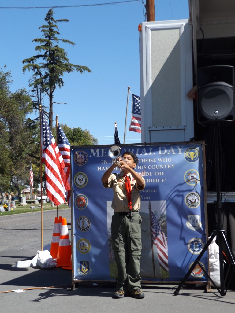 Jean Espinosa of Boy Scout Troop 450 plays Taps to close out the ceremony.
