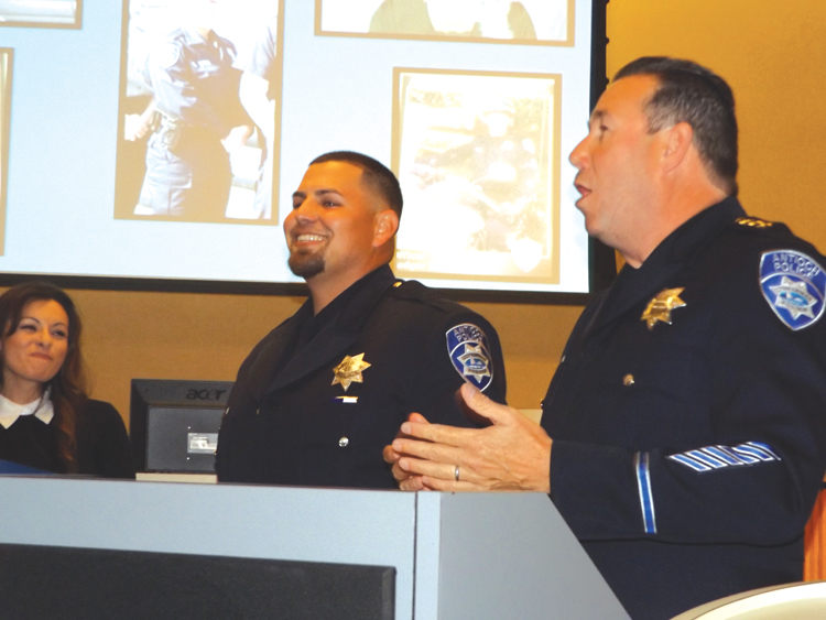 Antioch Police Chief Allan Cantando (right) speaks about Officer of the Year Michael Mortimer during the awards ceremony on Thursday, May 14, 2015.