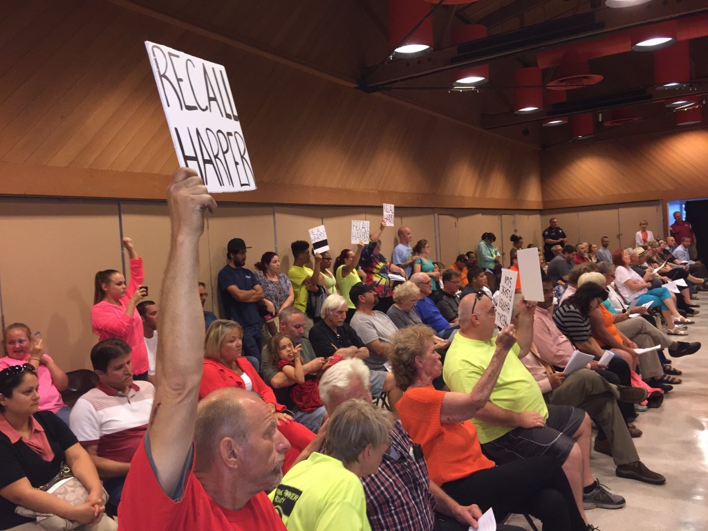 Linda Hudson, center in orange shirt, holds a sign supporting Mayor Harper's recall, along with supporters of the speed bumps on 11th Street in front of her house, while Kip Stevens spoke at the joint study session of the Antioch City Council, Planning Commission and Economic Development Commission on Tuesday, June 2, 2015. photo by Allen Payton