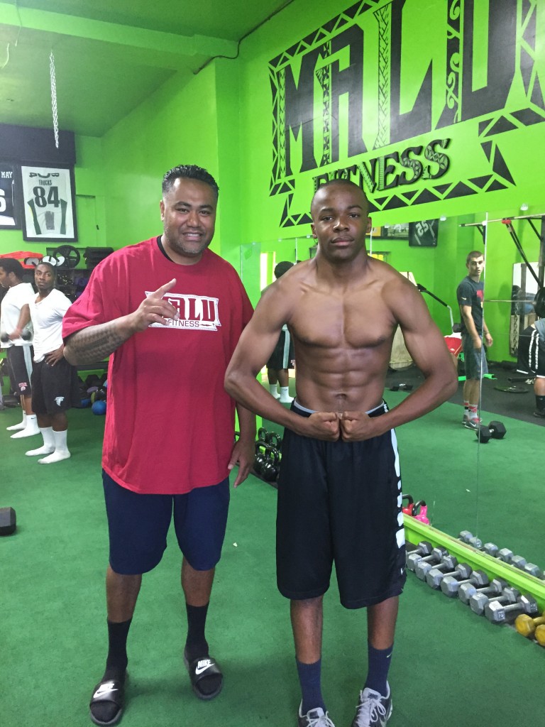 Isaiah Foskey flexing next to trainer Mori Suesue at Malu Fitness in Antioch. photo by Marcus Malu 