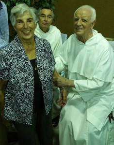 Bea Neal greets Fr. Vicente in the receiving line, as Fr. Roberto looks on