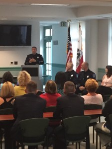 Chief Cantando speaks at the ceremony, as new officers Harris and Downie, and newly promoted Dispatch Supervisor Stacey Malsom, friends, family and Antioch council members look on.