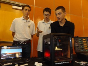 Hudson Preece, Kevin Roldan and Robert Gochenouer, juniors in the Antioch High EDGE Academy explain the workings of the 3D printer at their display.