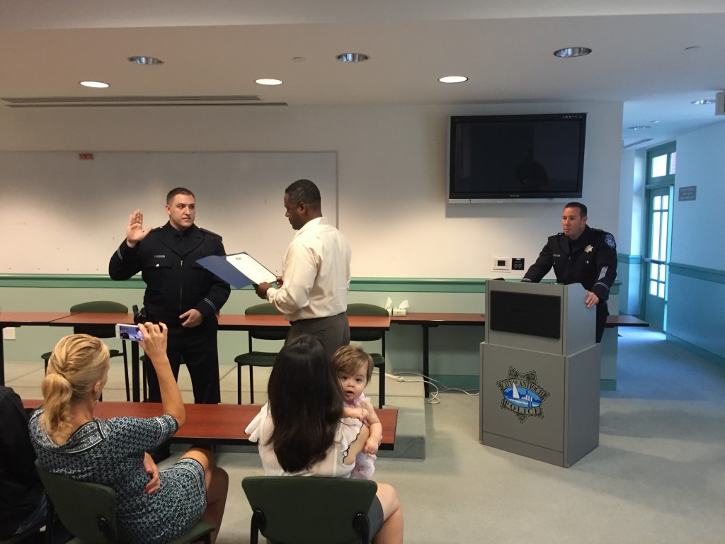 New Antioch Police Officer Justin Hamilton is administered the oath of office by Mayor Wade Harper as Chief Allan Cantando and Hamilton's family look on, during a ceremony on Monday, October 12, 2015.
