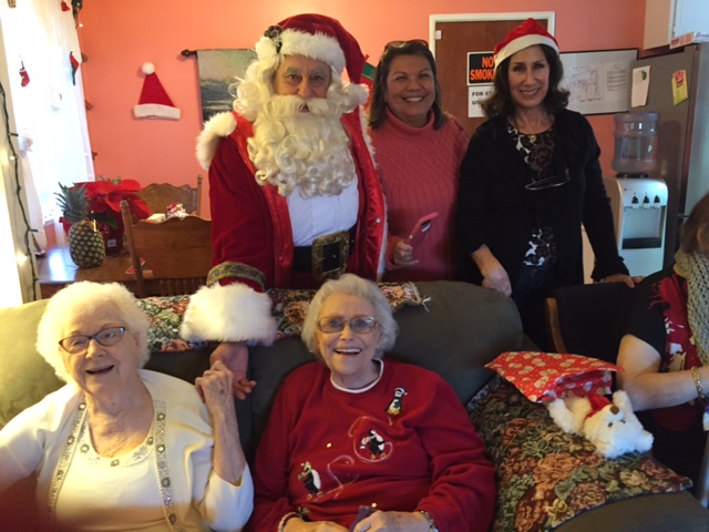 Residents of Cobblestone Care Home in Antioch, Hazel Shelton and Fern Chisum are greeted by Santa (aka Angelo Pappas), Manager Angie Ramandanen and AEWF Board Member Sandy Fredrickson during the Santa for Seniors on Wednesday, December 16, 2015.