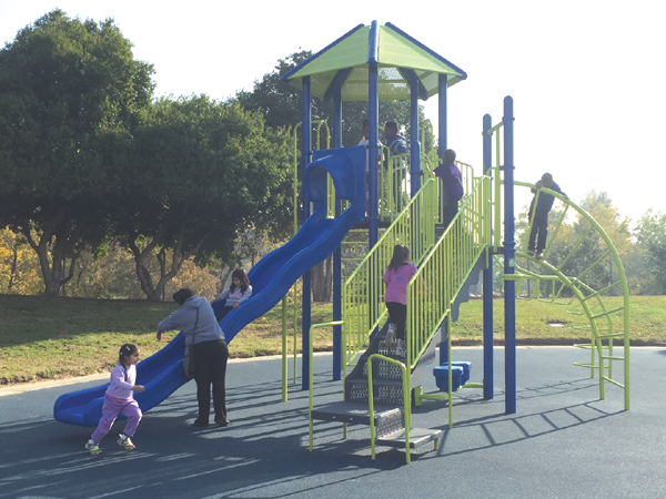 Children play on the new playground at Contra Loma Estates Park, Saturday, November 20, 2015.
