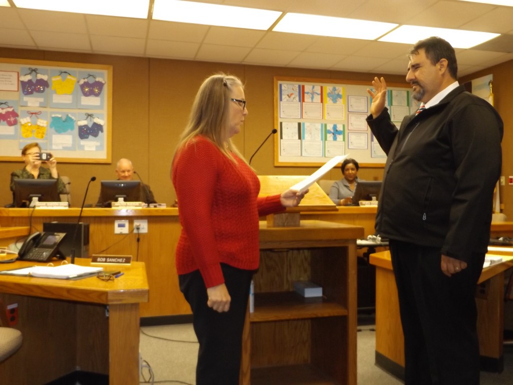 New Antioch School Board Trustee Fernando Navarro takes his oath of office administered by Board President Claire Smith, Wednesday afternoon, December 9, 2015.