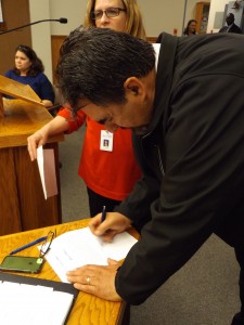 Fernando Navarro signs his Oath of Office to officially become Antioch's newest schools trustee.