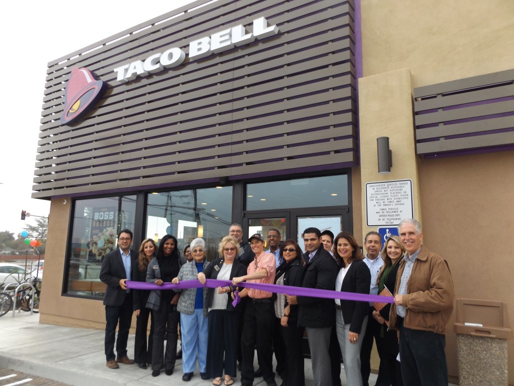 Manager Carrie Landgraf prepares to cut the ribbon, Antioch Council Members and property owner S G Ellison, Franchisee and CEO Randy Rodriguez and COO Monica Schneider, and staff of Golden Gate Bell, LLC and the new Taco Bell.