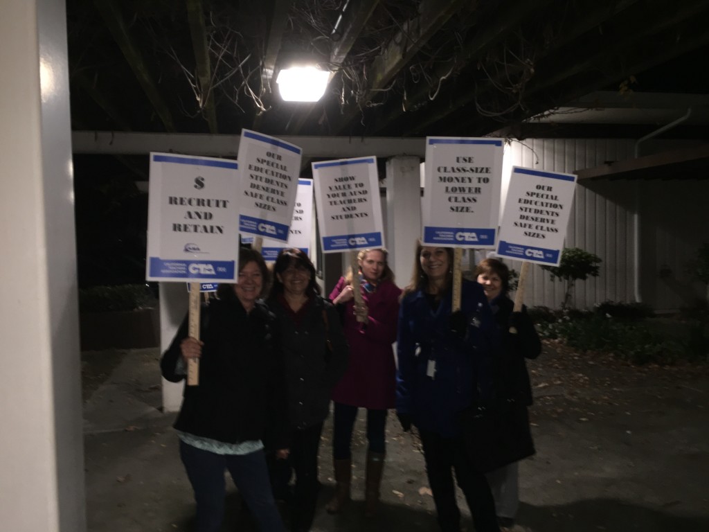 Antioch teachers march, wave signs and chant outside the School Services Building before the Antioch School Board meeting on Wednesday, January 20, 2016.