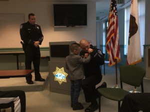 New Lt. Desmond Bittner is pinned with the help of his son.