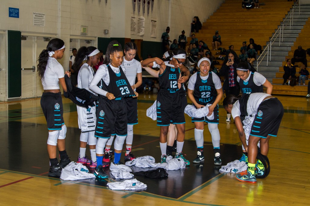 Deer Valley girls basketball team members remove their jerseys in protest before the game on Thursday, February 11, 2016. photo by Michael Pohl