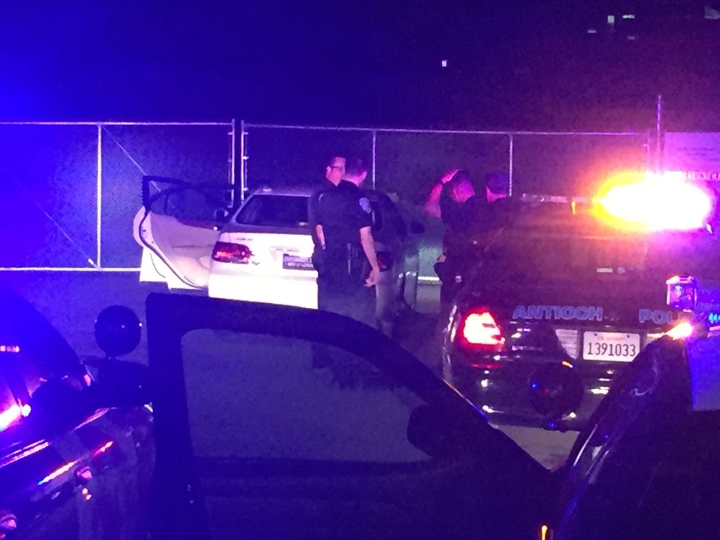 Antioch Police investigate the suspect's car at the end of the BART Park n Ride lot access road, following the end of the chase, late Monday night/early Tuesday morning.