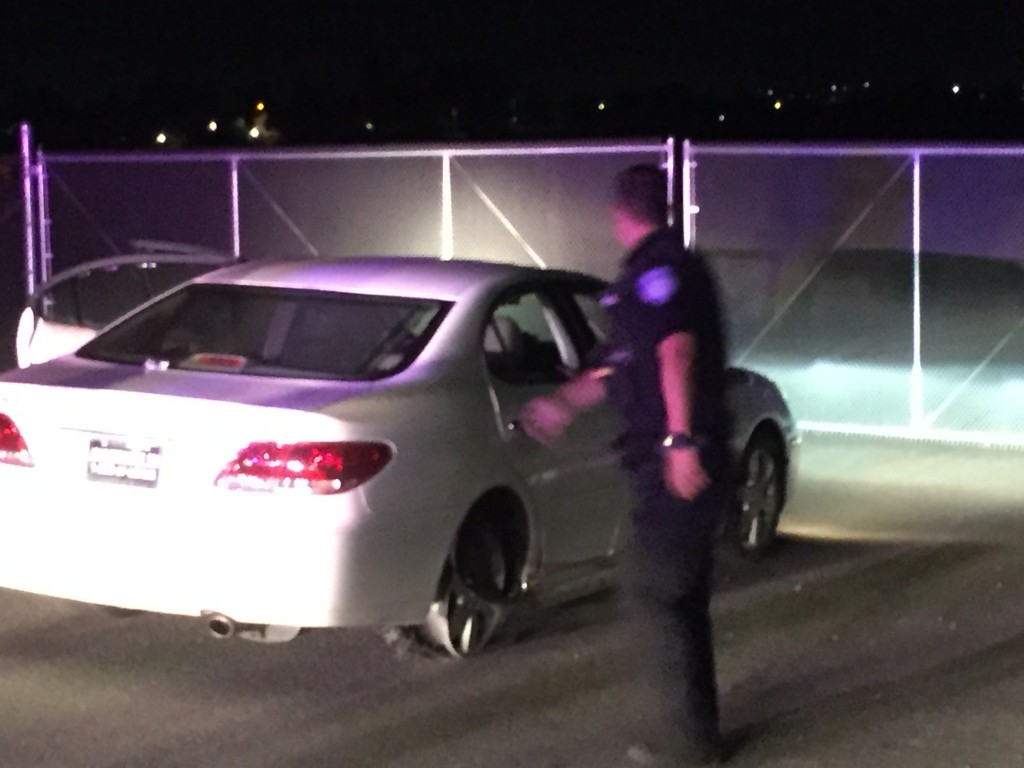 The suspect's car with the rear passenger tire worn down to the wheel.