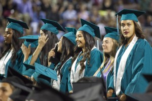 Deer Valley girl grads stand for their turn to receive their diplomas.