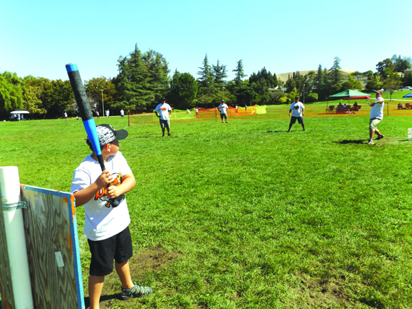 One of Keith Pearson's sons, Peyton, prepares to swing during the annual Whiffle Ball tournament in Antioch.