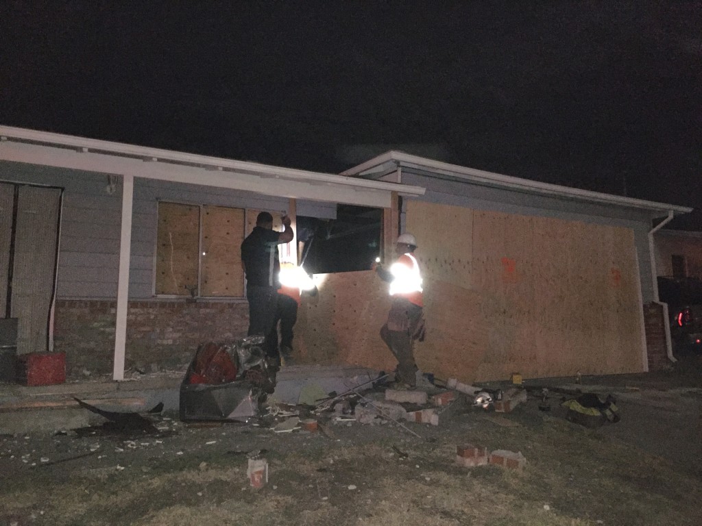 A crew was still working at 11:00 p.m. to board up the house one Lone Tree Way in which a drunk truck driver crashed into Thursday evening. Photo by Allen Payton