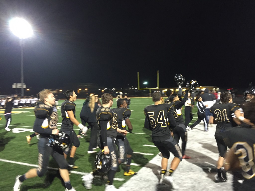 Antioch High players raise their helmets in victory as they leave the field following their 38-31 win over the Cal High Grizzlies, Saturday night, November 19, 2016