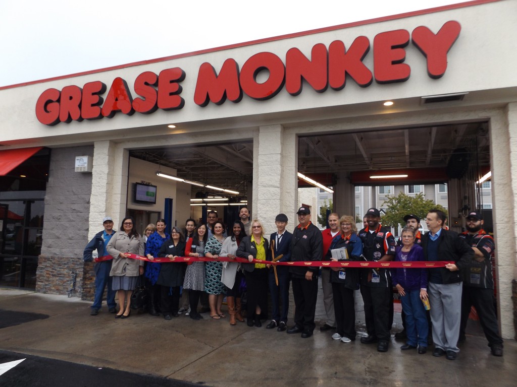 Owner Brian Li, with scissors, prepares to cut the ribbon to officially open the new Grease Monkey in Antioch on Friday, October 28, 2016.