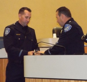New Antioch Police Officer Jason Cash is presented with his badge by Chief Cantando.
