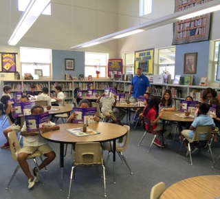 Antioch Rotarian Jeff Warrenburg delivers dictionaries to third-graders at John Muir Elementary in November.