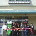 Owner Bill Byrnes prepares to cut the ribbon